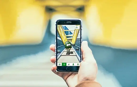 A first-person perspective onto a hand holding a smartphone in front of an urban bridge, showing the scenerie on the display, augmented by a digitally drawn figure